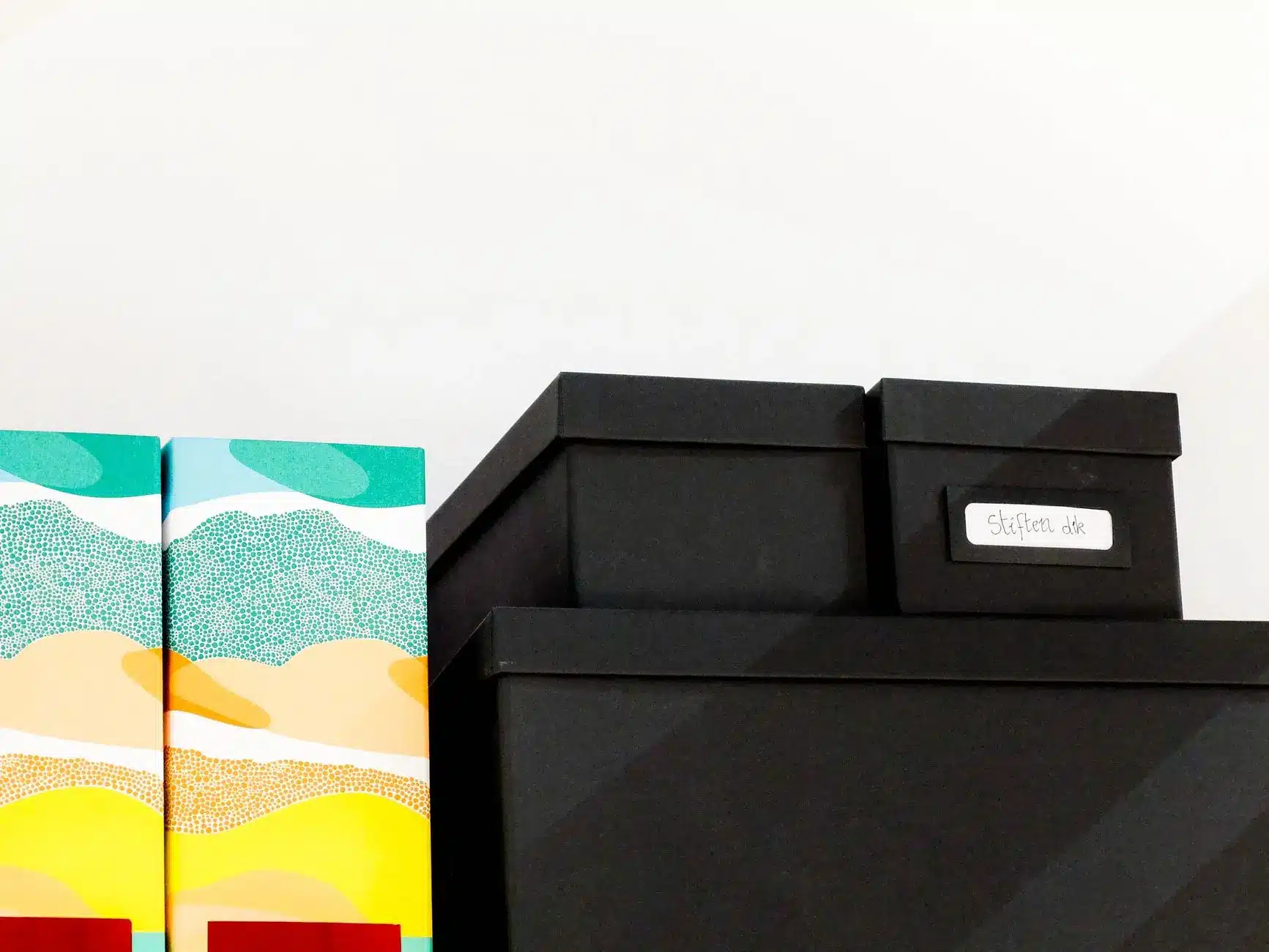 Stack of four cardboard boxes on a blue background