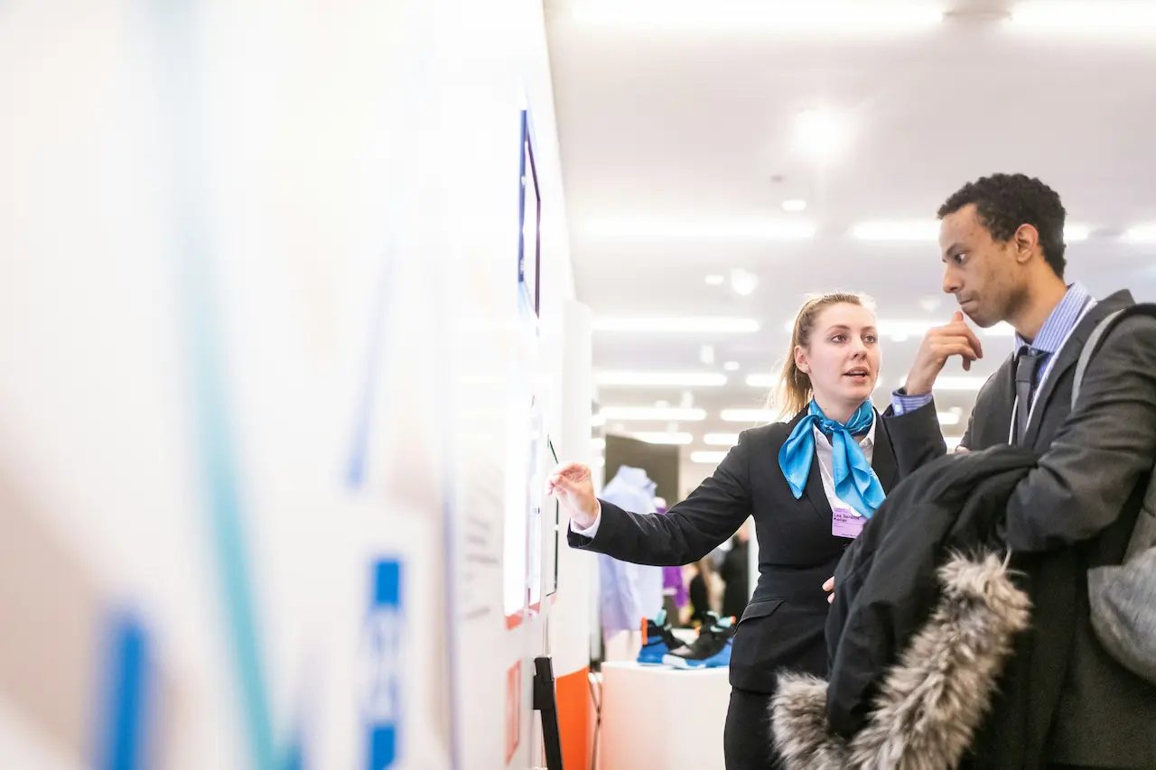 recruitment booth for a job fair with clear signage on open positions